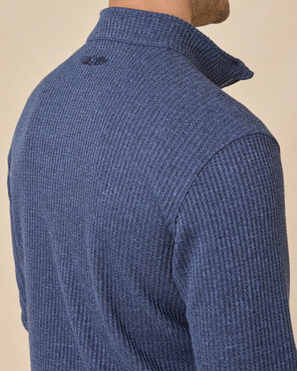 Close-up back view of the Huntington Quarter Zip in New Indigo, highlighting the textured knit and tonal embroidered logo below the collar.
