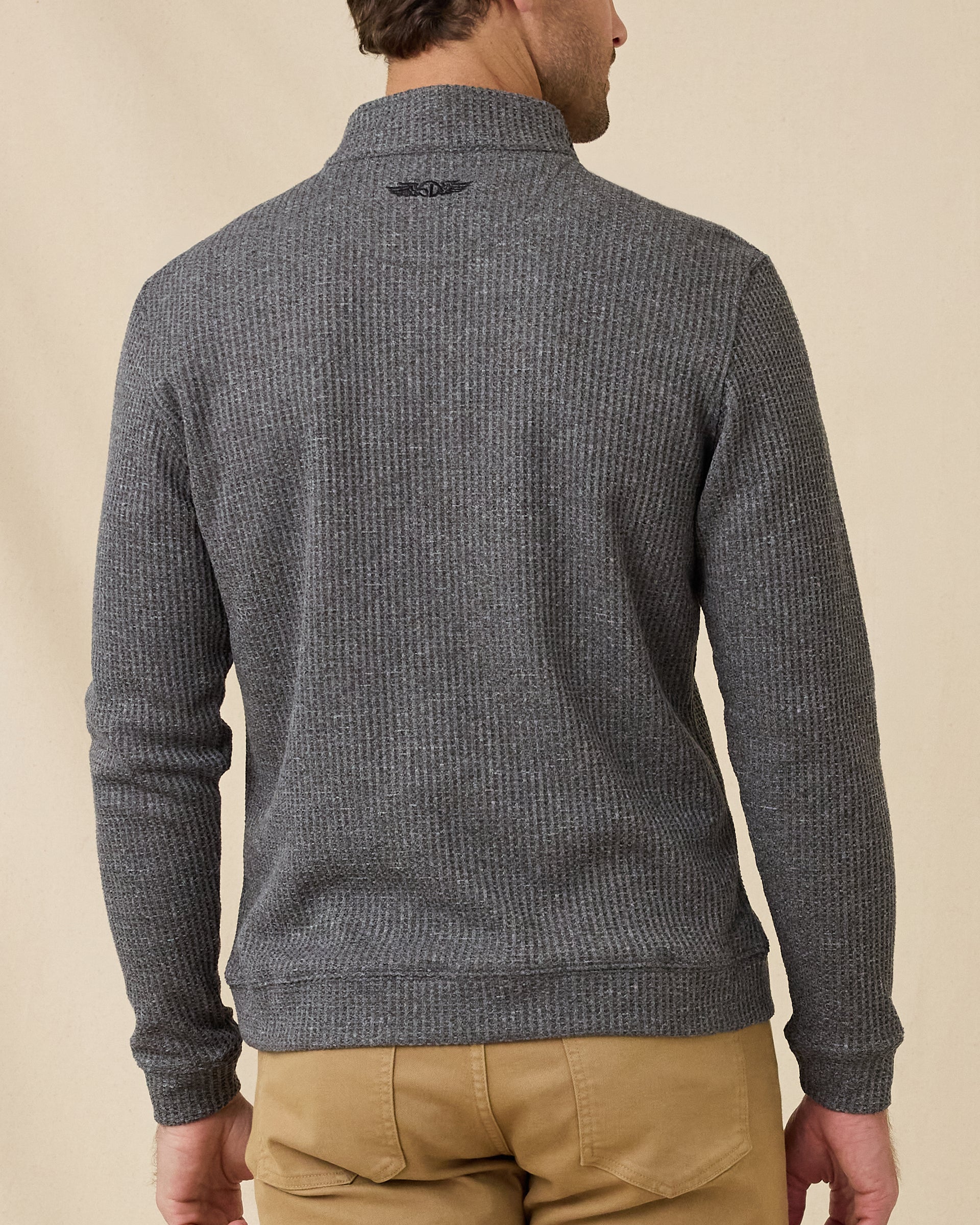 Rear view of the black Huntington Quarter Zip, showing the textured waffle knit and embroidered logo below the back collar.
