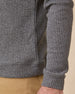 Close-up of the black Huntington Quarter Zip showing the textured fabric, banded hem, and sleeve cuff.