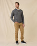 Model wearing the black Huntington Quarter Zip with tan pants and black sneakers.