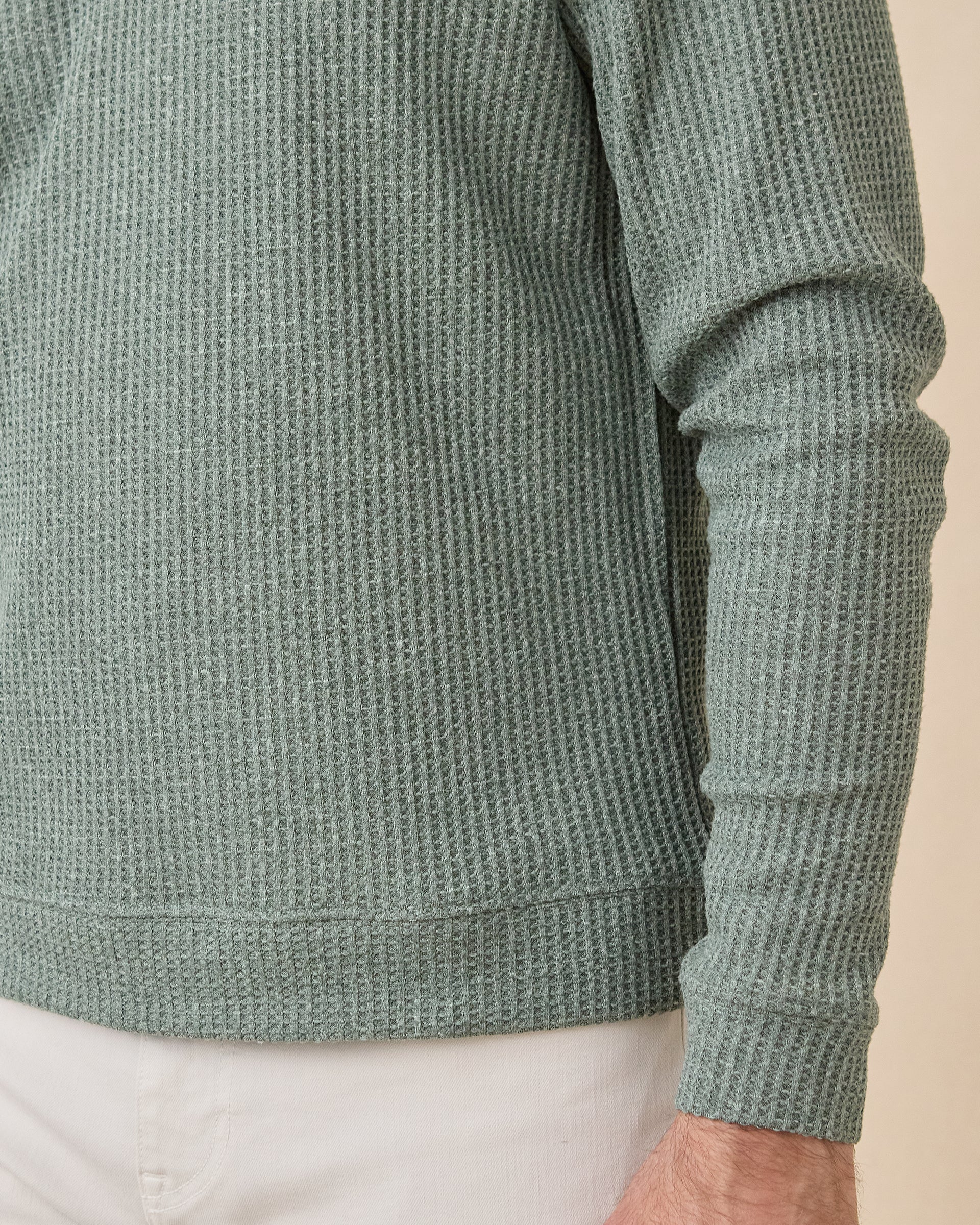 Close-up of the Dark Forest Huntington Quarter Zip showing the textured waffle knit, banded hem, and sleeve cuff.