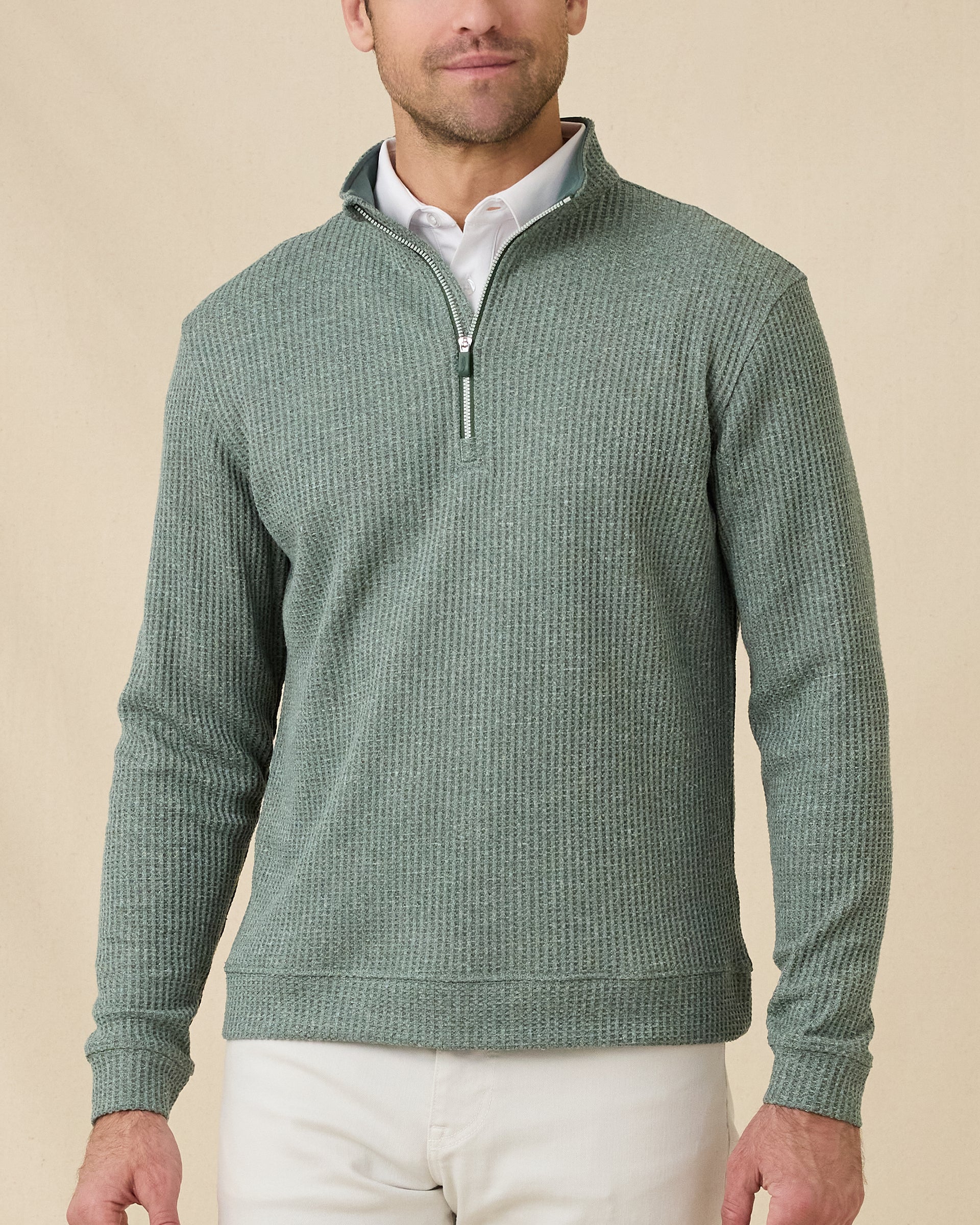 Model wearing the Dark Forest Huntington Quarter Zip layered over a white polo with light-colored pants.