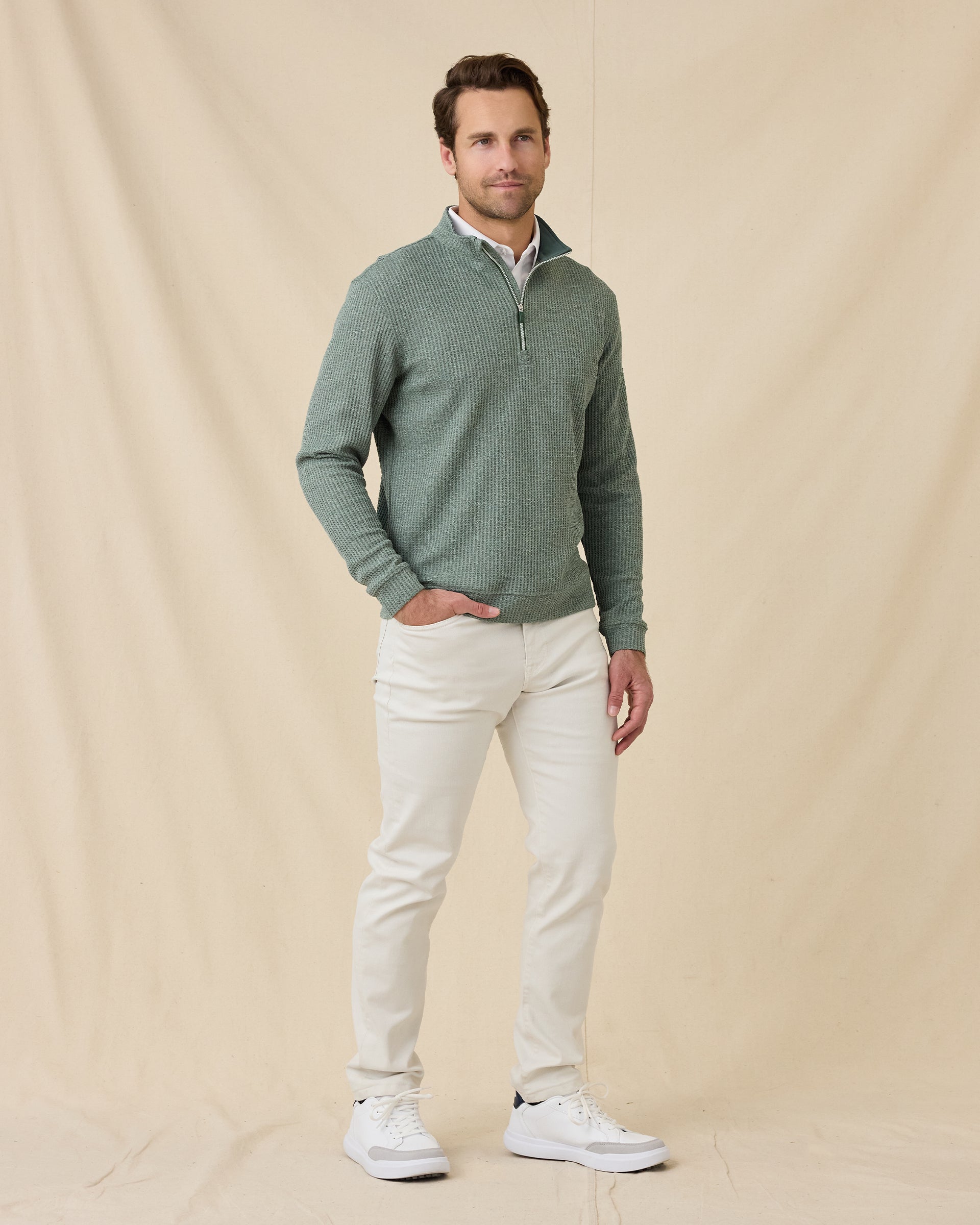 Model wearing the Dark Forest Huntington Quarter Zip with light-colored pants and white sneakers.