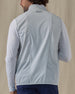 Men's Zephyr Hybrid Vest in Silver, back view on model featuring a solid light gray body with a Straight Down logo embroidered at the upper back, layered over a white long sleeve, paired with navy pants