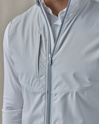 Men's Zephyr Hybrid Vest in Silver, close-up front view highlighting the full zip closure detail and chest pocket on the solid light gray body
