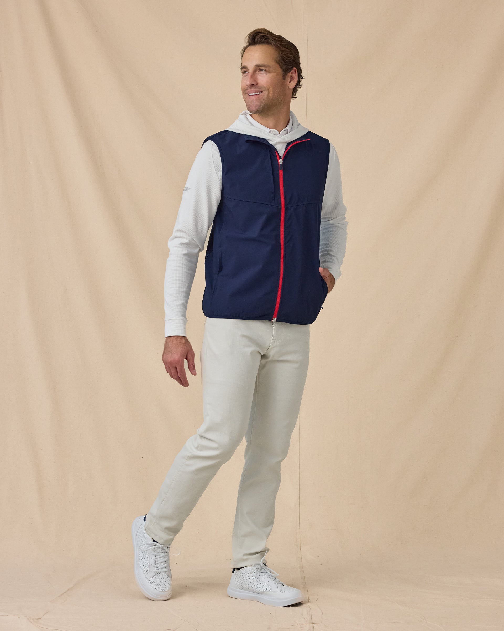 Men’s Zephyr Hybrid Vest in New Indigo / Flag Red, styled full outfit view with light pants