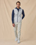 Men’s Zephyr Hybrid Vest in White / New Indigo, styled full outfit view with dark hoodie and light pants
