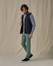 Men’s Zephyr Hybrid Vest in black, full outfit paired with green pants and layered over hoodie