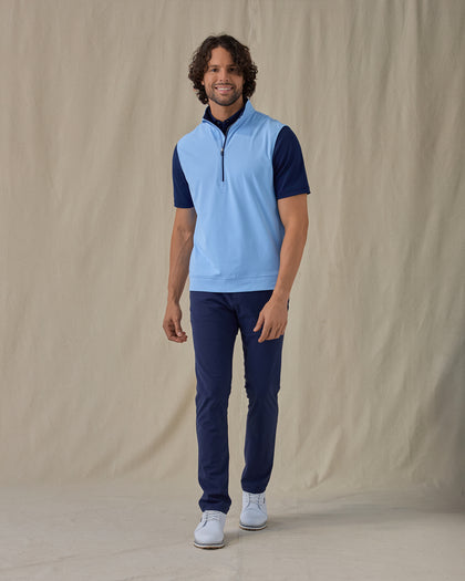 Men's Carson Vest in Carolina, on model front view full length styled over a navy polo with navy pants and white golf shoes