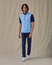 Men's Carson Vest in Carolina, on model front view full length styled over a navy polo with navy pants and white golf shoes
