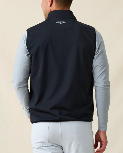 Men's Delta 2.0 Quilted Hybrid Vest in Black, back view on model featuring the Straight Down logo at the upper back, layered over a gray long sleeve shirt, paired with white pants