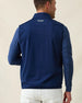 Men's Delta 2.0 Quilted Hybrid Vest in New Indigo, back view on model featuring the Straight Down logo at the upper back, layered over a navy long sleeve shirt, paired with white pants