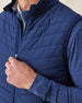 Men's Delta 2.0 Quilted Hybrid Vest in New Indigo, close-up front view on model highlighting the quilted panel texture and full zip closure detail