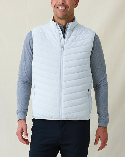 Men's Delta 2.0 Quilted Hybrid Vest in Silver, front view on model featuring a light silver quilted front panel with full zip closure, layered over a gray long sleeve shirt, paired with navy pants