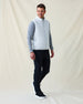 Men's Delta 2.0 Quilted Hybrid Vest in Silver, full length side view on model featuring a light silver quilted front panel with full zip closure, layered over a gray long sleeve shirt, paired with navy pants and black shoes