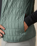 Close-up of the Big Horn Quilted Vest in Dark Forest, highlighting the grid quilting and zippered hand pocket with orange accents.