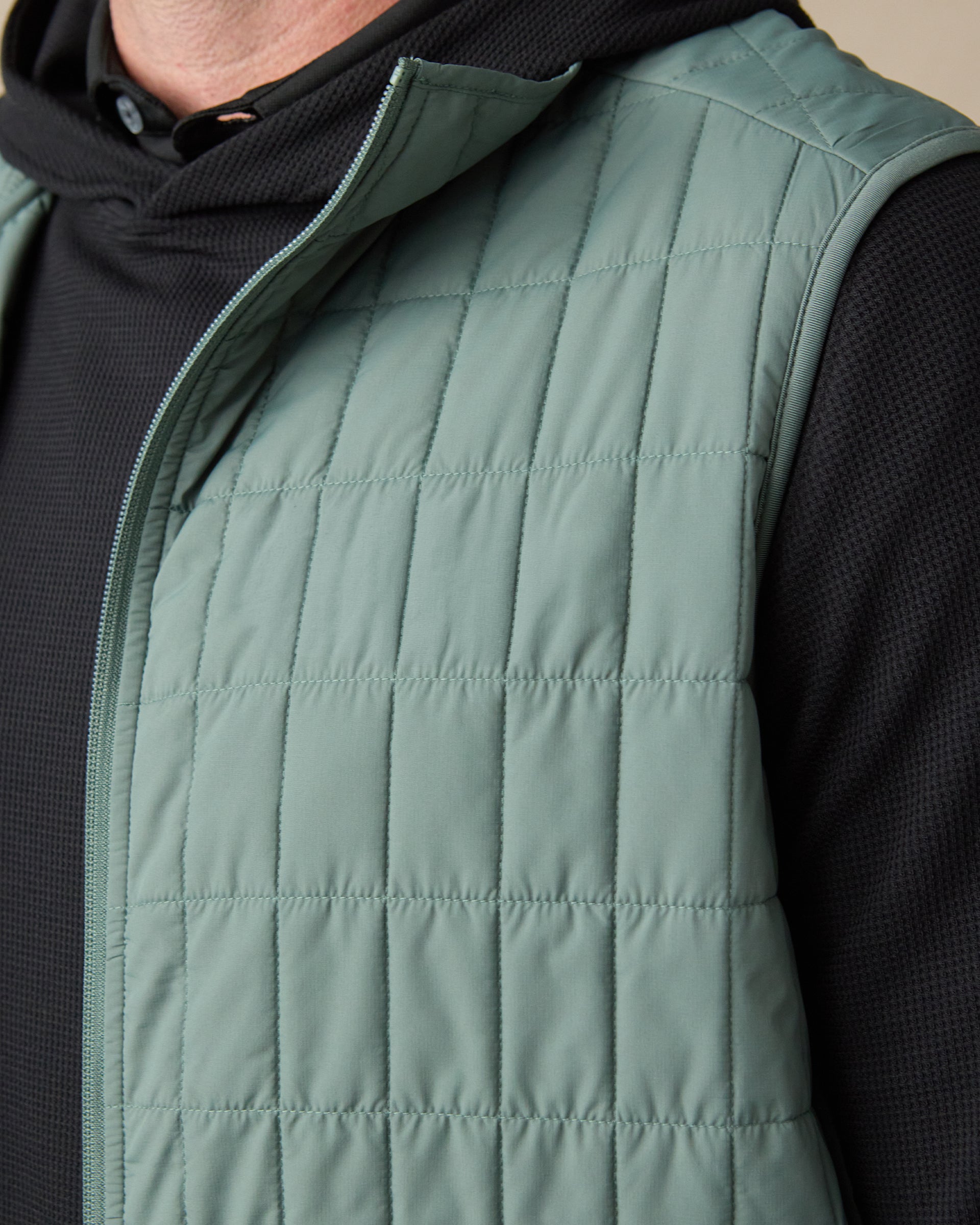 Close-up of the Big Horn Quilted Vest in Dark Forest, featuring lightweight grid quilting, a full-zip front, and stand collar.