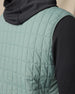 Back view of the Big Horn Quilted Vest in Dark Forest, highlighting the grid quilting and stretch side panel.
