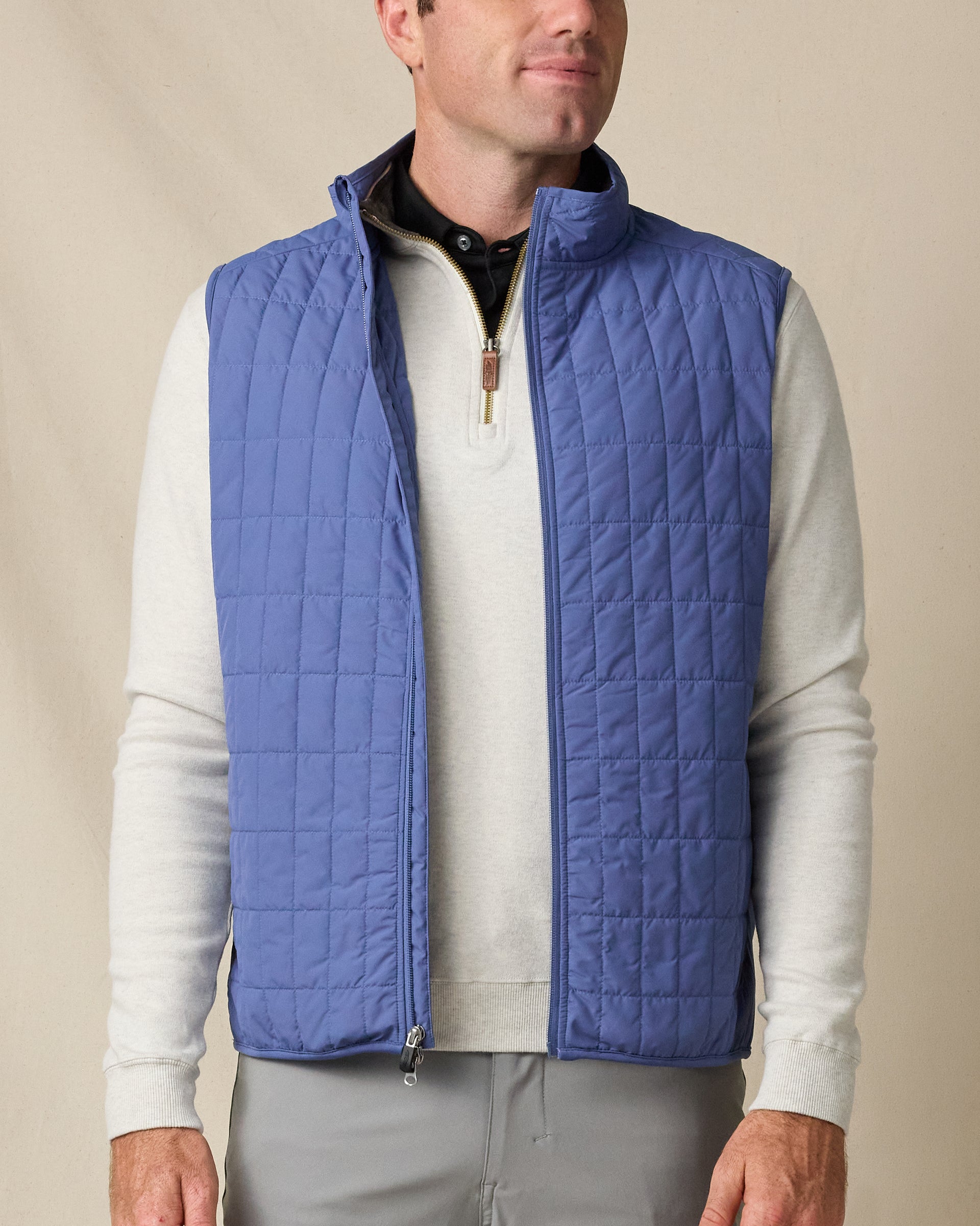 Model wearing the Big Horn Vest in Moonlight, featuring grid quilting, a full-zip front, and stand collar.