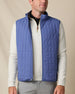 Model wearing the Big Horn Vest in Moonlight, featuring grid quilting, a full-zip front, and stand collar.