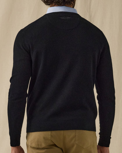 Men's Ballesteros V-Neck Sweater in Black, on model back view featuring a black fine knit v-neck sweater with Straight Down logo at the upper back and ribbed cuffs and hem