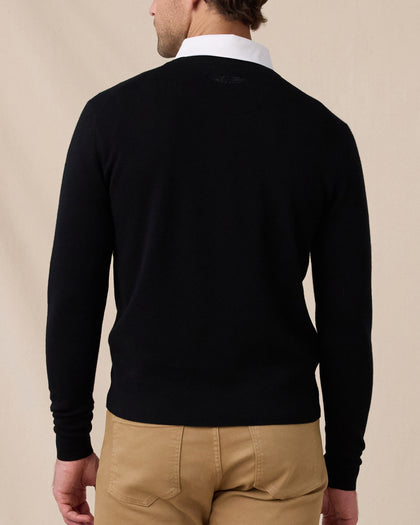 Back view of the black Connery V-Neck Sweater featuring a subtle tonal logo below the collar.