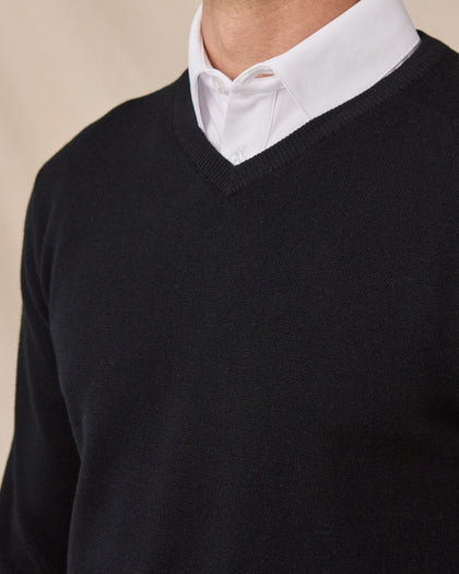 Close-up of the black Connery V-Neck Sweater showing the fine knit fabric and ribbed V-neck over a white collared shirt.