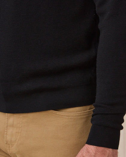 Close-up of the black Connery V-Neck Sweater showing the fine knit fabric, ribbed hem, and ribbed sleeve cuff.