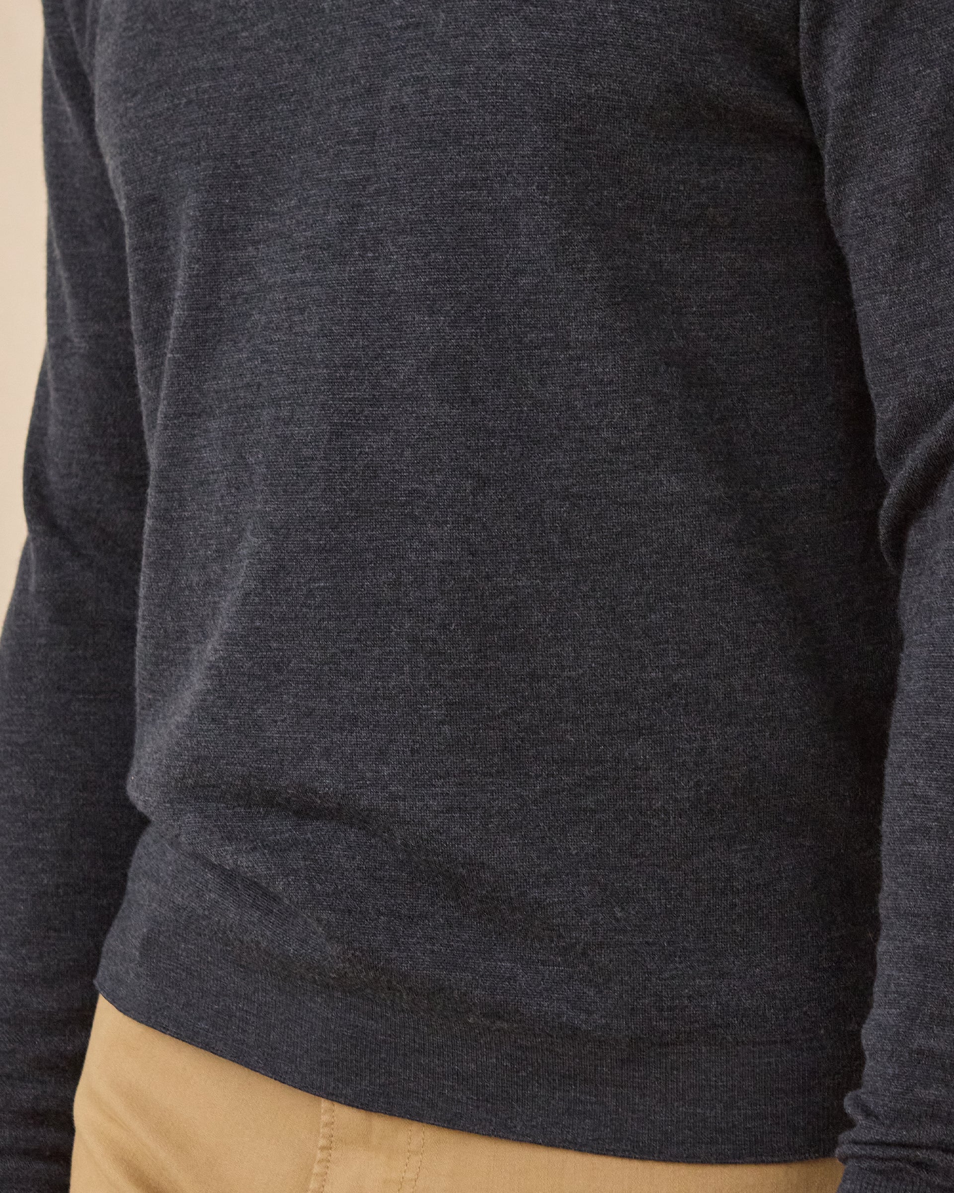 Close-up of the Dark Grey Heather Connery V-Neck Sweater showing the fine knit texture and ribbed hem.
