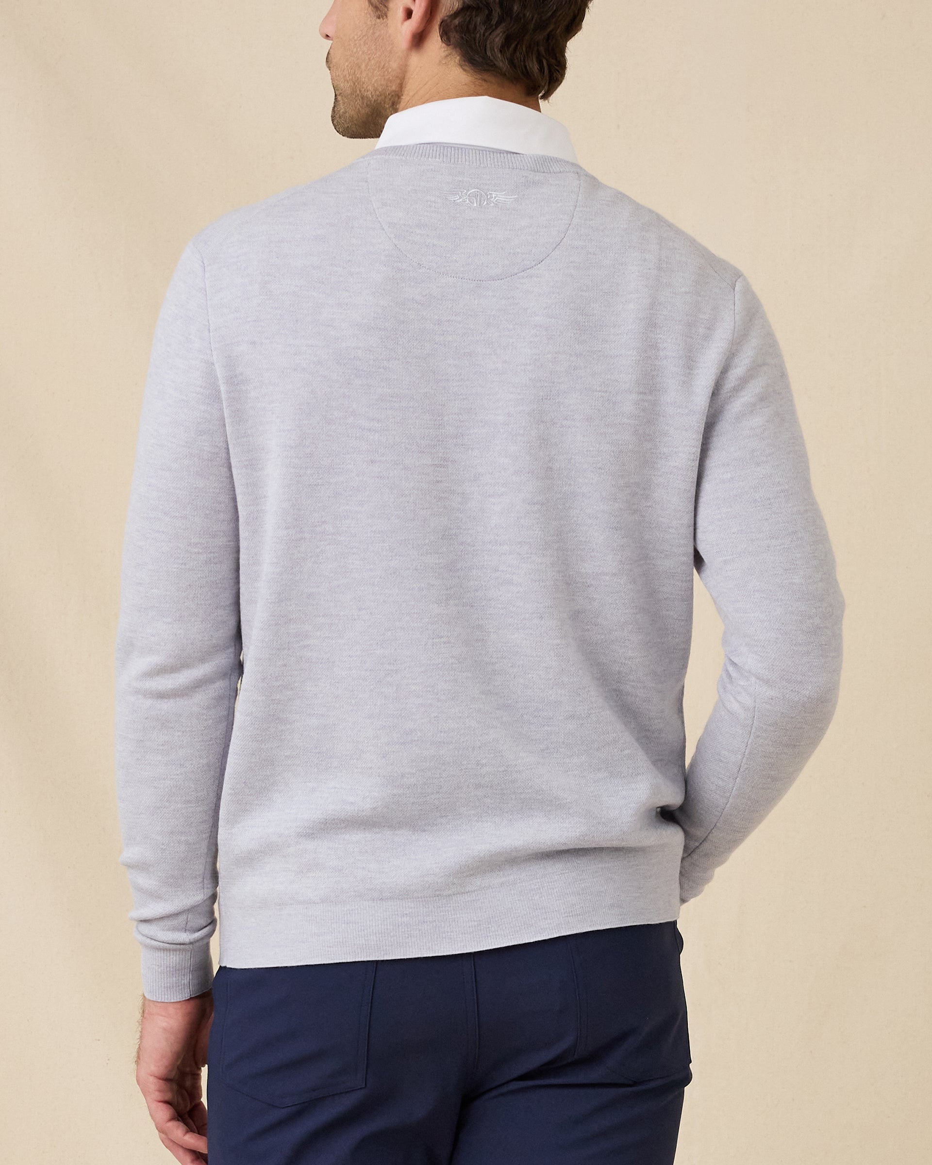 Back view of the Light Grey Connery V-Neck Sweater featuring a subtle embroidered logo below the collar.