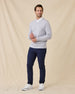 Man wearing the Light Grey Connery V-Neck Sweater over a white collared shirt, paired with navy pants and white sneakers.
