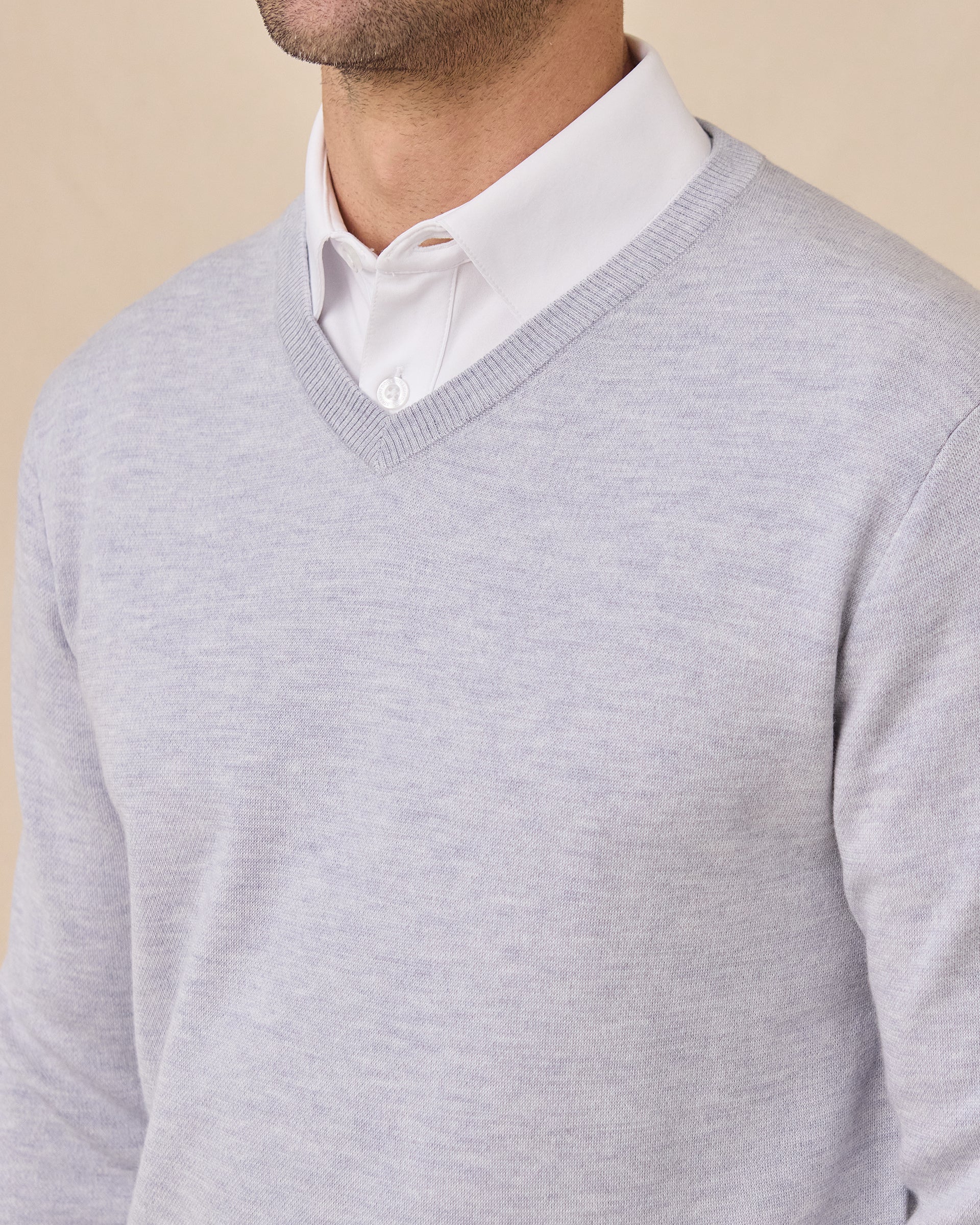 Close-up of the Light Grey Connery V-Neck Sweater showing the fine knit texture and ribbed V-neck over a white collared shirt.