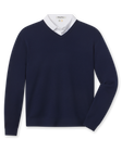 A navy blue V-neck knit sweater styled with a white collared shirt underneath.