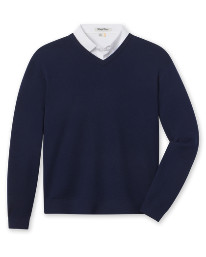 A navy blue V-neck knit sweater styled with a white collared shirt underneath.