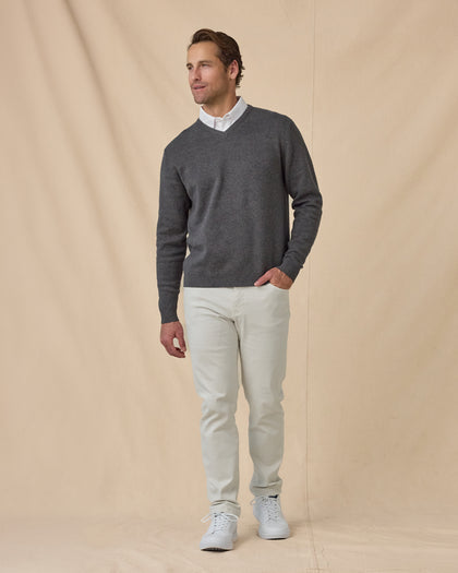 Wallace V-Neck Sweater in Dark Grey Heather with white pants, full outfit view layered over white polo and styled with light pants