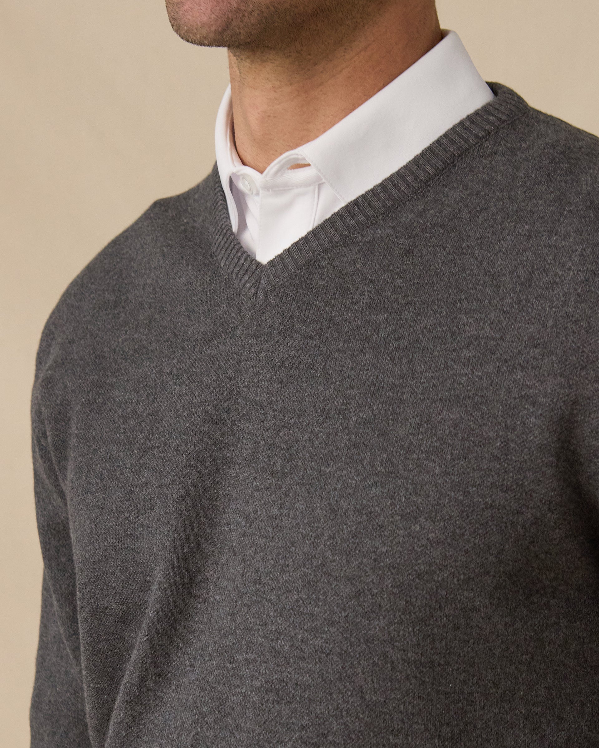 Wallace V-Neck Sweater in Dark Grey Heather layered over white button-down, v-neck detail view