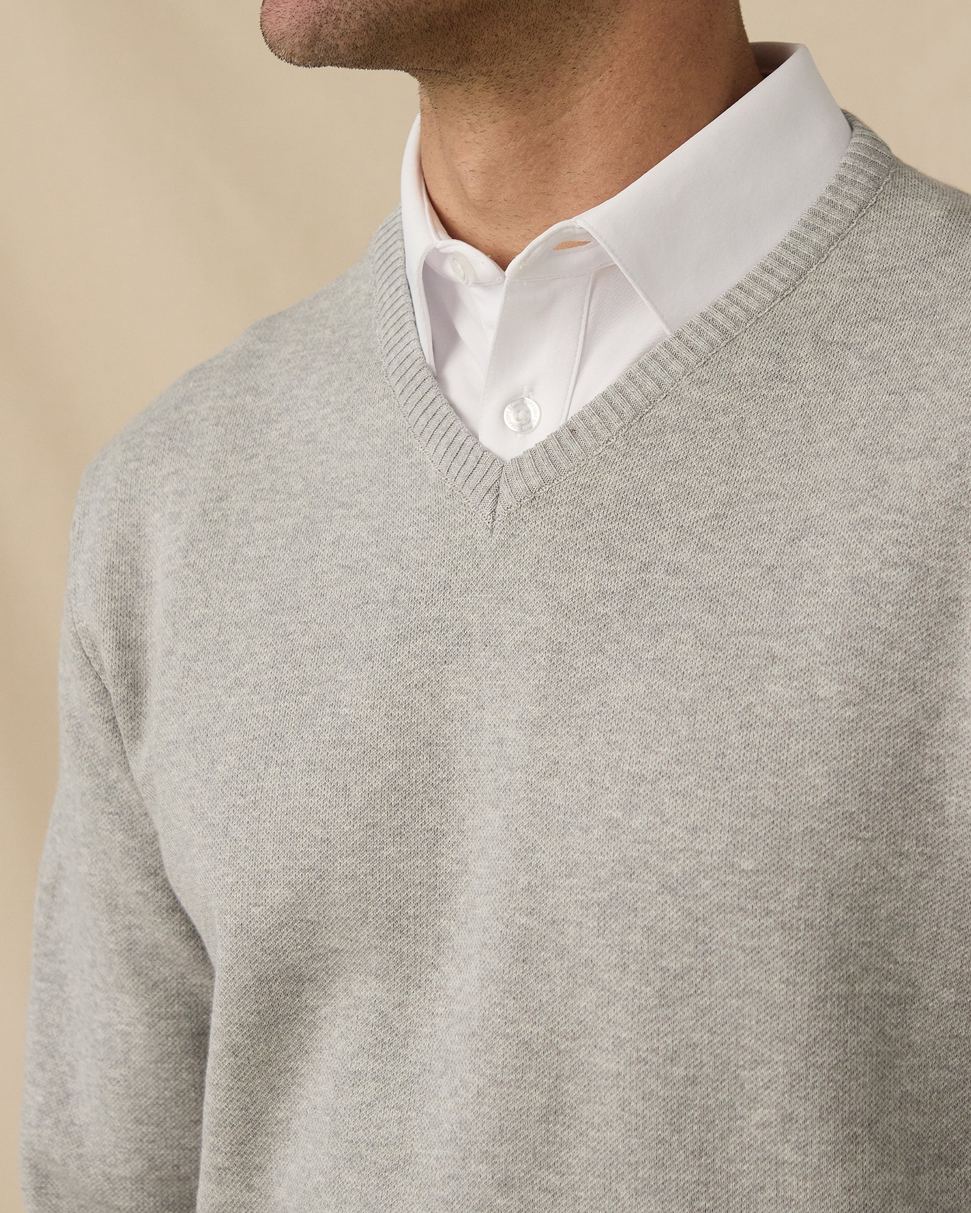 Wallace V-Neck Sweater in Light Grey Heather layered over white polo, v-neck detail view