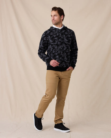 Model wearing the Crenshaw Reversible Sweater Hoodie in Charcoal with tan pants and black sneakers.