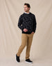 Model wearing the Crenshaw Reversible Sweater Hoodie in Charcoal with tan pants and black sneakers.
