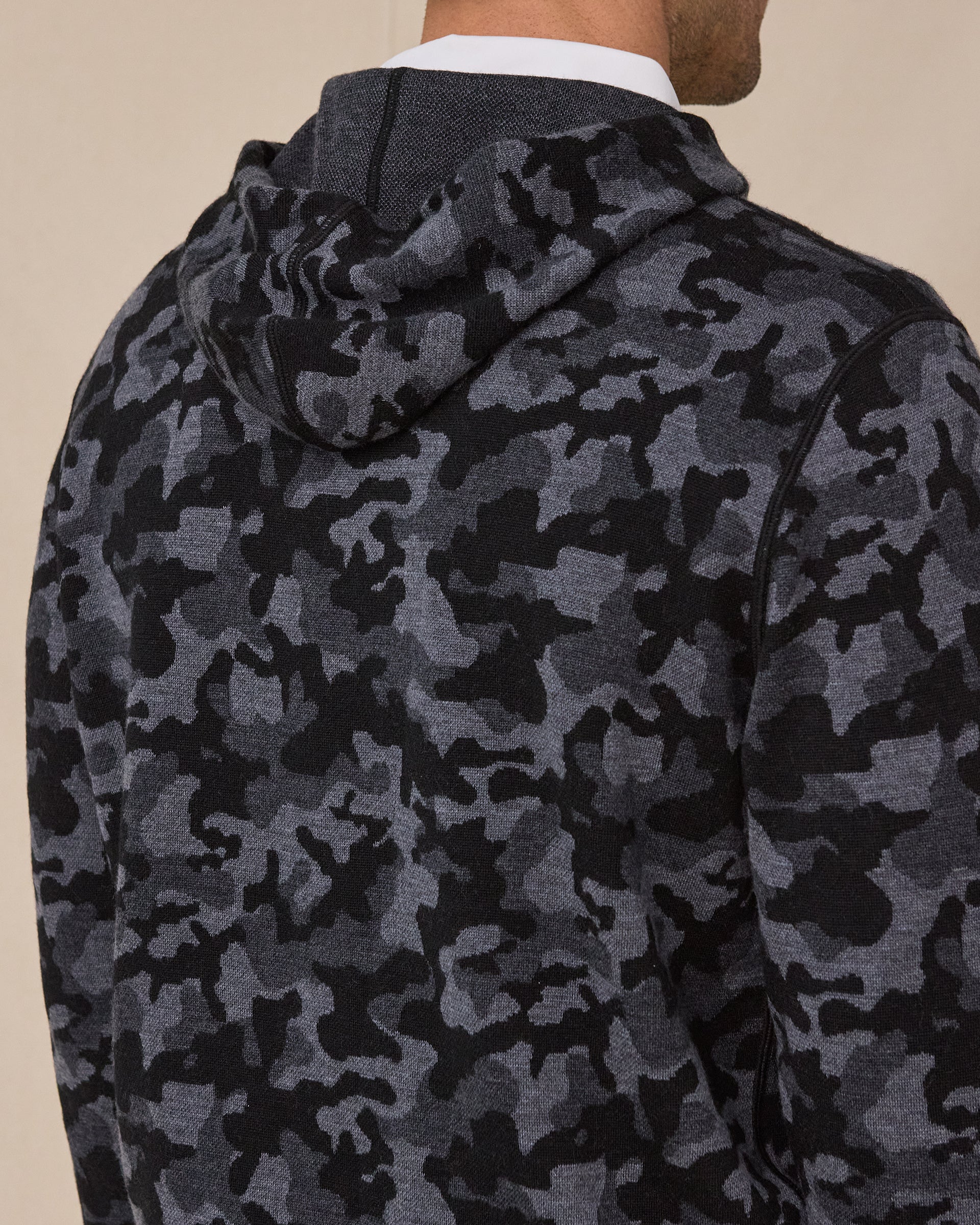 Close-up of the Crenshaw Reversible Sweater Hoodie in Charcoal highlighting the camouflage knit pattern, hood, and shoulder detailing.