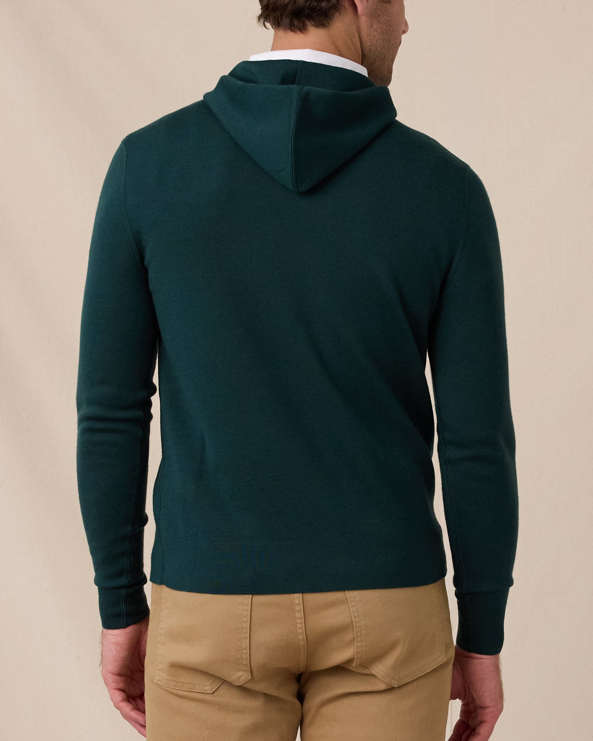 Back view of the Crenshaw Reversible Sweater Hoodie in Dark Forest showing the hood, clean silhouette, and ribbed hem and cuffs.