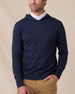 Model wearing the Crenshaw Reversible Sweater Hoodie in New Indigo layered over a white polo, front model view