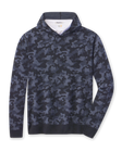Hickam Reversible Sweater Hoodie in camouflage New Indigo layered over a white polo, front view