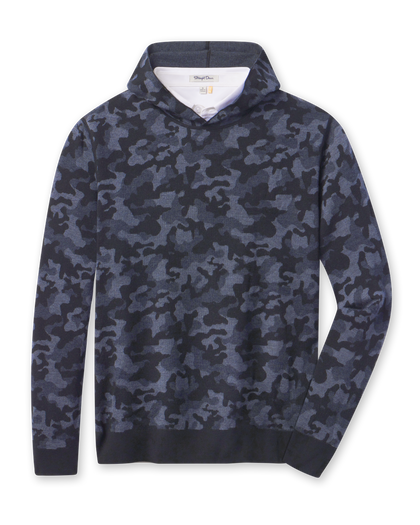 Hickam Reversible Sweater Hoodie in camouflage New Indigo layered over a white polo, front view