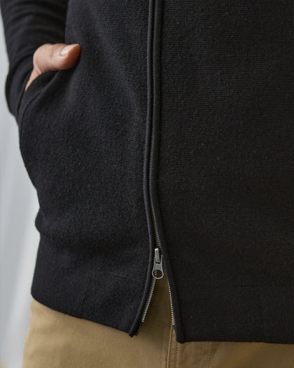 Men's Sarazen Knit Bomber in Black, on model close-up view featuring fine knit texture detail, side pocket with hand inserted, and gunmetal zipper hardware