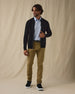 Men's Sarazen Knit Bomber in Black, on model front full-length view featuring an open zip black fine knit bomber with stand collar worn over a light blue polo paired with khaki pants and shoes