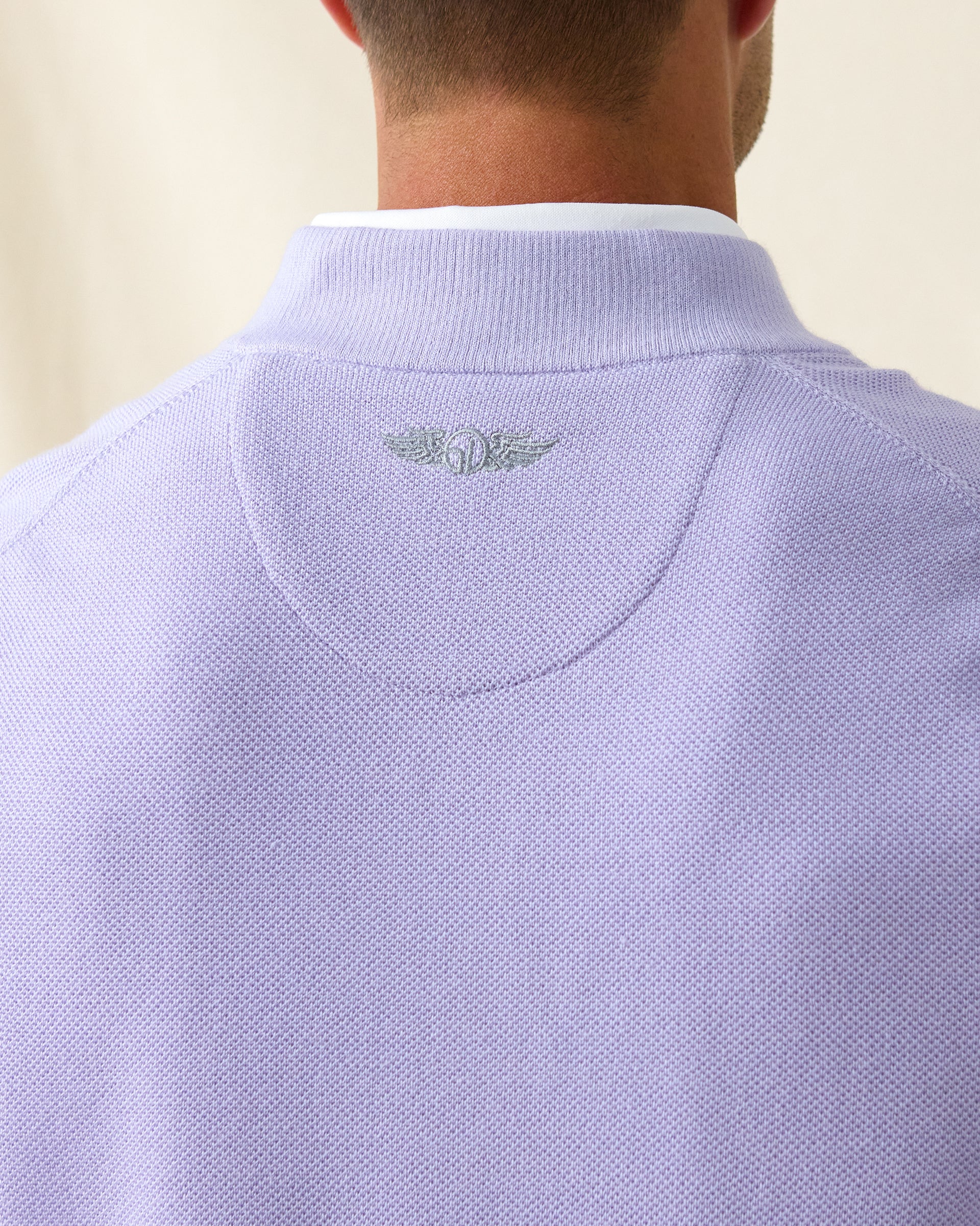 Men's St. Andrews Quarter Zip in Violet Heather, close-up back neck view on model highlighting the tonal Straight Down logo embroidered at center back neck and textured knit detail