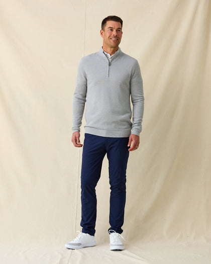 Men's St. Andrews Quarter Zip in Heather, full length front view on model featuring a light heather gray textured knit with quarter zip closure, paired with navy pants and white shoes