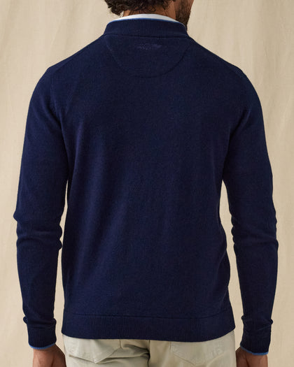 Men's Lakeside Quarter Zip Sweater in New Indigo, back view on model featuring a solid navy knit body with the Straight Down logo embroidered at the upper back, worn with light grey pants