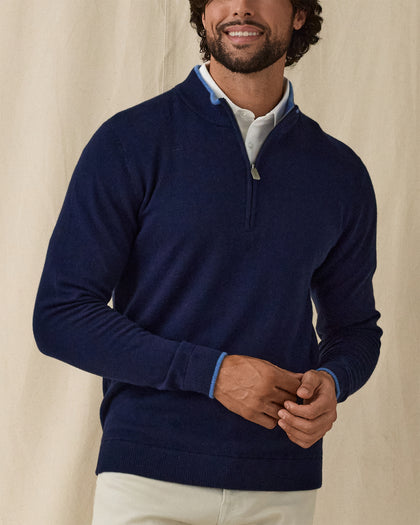Men's Lakeside Quarter Zip Sweater in New Indigo, front view on model featuring a solid navy knit body with light blue tipped collar and cuffs, layered over a white polo, worn with light grey pants